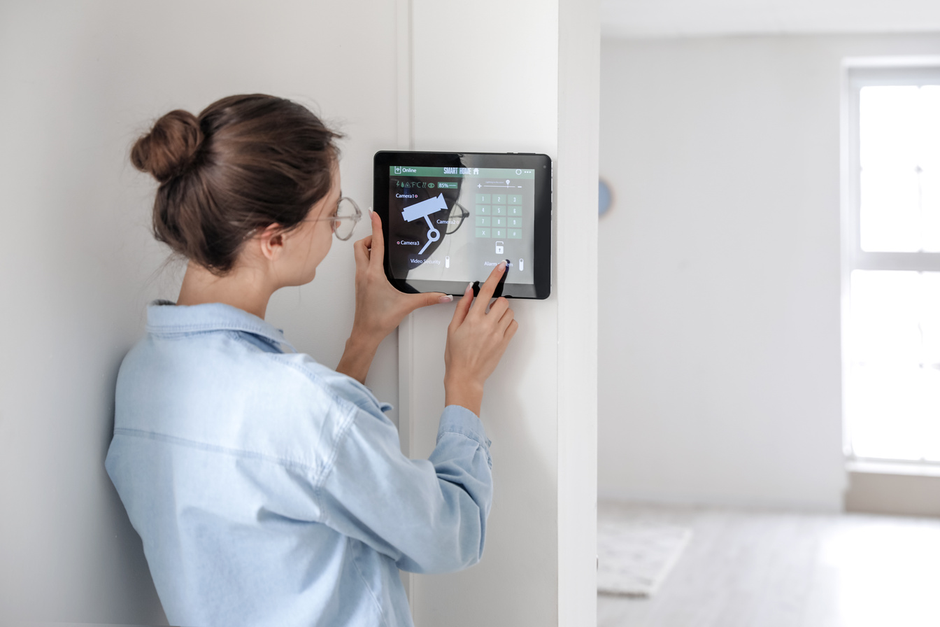 Woman Using Smart Home Security System Control Panel